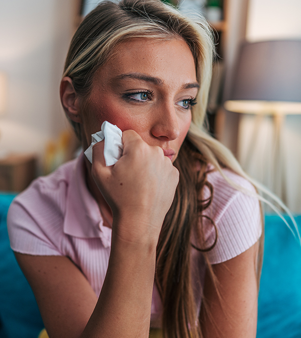 woman wiping tears